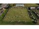 Aerial view of well-manicured lawn bowling with active players, and lush green landscaping at 2413 Oxford Down Ct # 58, Sun City Center, FL 33573