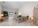 Spacious living room with vaulted ceilings and access to the screened patio, perfect for relaxation at 2413 Oxford Down Ct # 58, Sun City Center, FL 33573