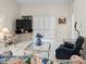 Bright living room with tile flooring, a glass coffee table, and sliding glass doors at 2413 Oxford Down Ct # 58, Sun City Center, FL 33573