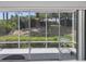 Inviting screened patio with tiled floor, perfect for relaxing and enjoying the serene backyard scenery at 2413 Oxford Down Ct # 58, Sun City Center, FL 33573