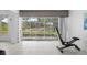 Sunroom featuring tile flooring, exercise equipment and expansive glass doors providing abundant natural light at 2413 Oxford Down Ct # 58, Sun City Center, FL 33573