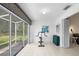 Bright sunroom with tiled floor, exercise equipment and sliding glass doors providing ample sunlight at 2413 Oxford Down Ct # 58, Sun City Center, FL 33573