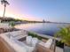Relaxing backyard patio setup with comfortable seating, tranquil waterfront views, and lush palm trees at 2807 W Hawthorne Rd # 11, Tampa, FL 33611