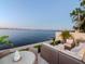 Outdoor patio area offering serene waterfront views, luxurious furniture, and tropical landscaping at 2807 W Hawthorne Rd # 11, Tampa, FL 33611