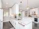 Spacious kitchen featuring a marble countertop, white cabinets, stainless steel appliances, and a mini-fridge at 2807 W Hawthorne Rd # 11, Tampa, FL 33611