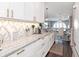 Bright, elegant kitchen showcases white cabinets, marble countertops, and stainless steel appliances at 2807 W Hawthorne Rd # 11, Tampa, FL 33611