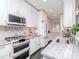 Modern kitchen features white cabinetry, designer backsplash, stainless steel appliances, and stylish accents at 2807 W Hawthorne Rd # 11, Tampa, FL 33611