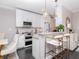 Bright kitchen with a breakfast bar, pendant lights, sleek white cabinets, and stainless steel appliances at 2807 W Hawthorne Rd # 11, Tampa, FL 33611