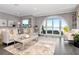 Comfortable living room with hardwood floors, plush seating, and an arched window that frames the waterfront at 2807 W Hawthorne Rd # 11, Tampa, FL 33611