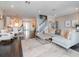 Open concept living room with dark floors, modern furniture, and easy access to kitchen and dining area at 2807 W Hawthorne Rd # 11, Tampa, FL 33611