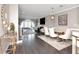 Open-concept living space featuring hardwood flooring, modern furnishings, and an arched window view at 2807 W Hawthorne Rd # 11, Tampa, FL 33611