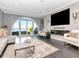 Inviting living room showcasing hardwood floors, stylish furniture, and an arched window with scenic water views at 2807 W Hawthorne Rd # 11, Tampa, FL 33611