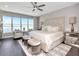 Beautiful main bedroom features a serene seating area, a luxurious bed, and large windows with waterfront views at 2807 W Hawthorne Rd # 11, Tampa, FL 33611