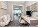 Home office with desk, seating, decor and a view of the living area with water views at 2807 W Hawthorne Rd # 11, Tampa, FL 33611