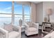Serene sitting area in the main bedroom features chairs, glass table, and large windows with waterfront views at 2807 W Hawthorne Rd # 11, Tampa, FL 33611