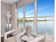Serene sitting area in the main bedroom features chairs, glass table, and large windows with waterfront views at 2807 W Hawthorne Rd # 11, Tampa, FL 33611