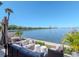 Spacious waterfront patio with comfortable seating, lush landscaping, and stunning views of the bay and skyline at 2807 W Hawthorne Rd # 11, Tampa, FL 33611