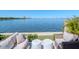 Inviting waterfront patio with cozy seating and lush landscaping, offering stunning views of the bay and city skyline at 2807 W Hawthorne Rd # 11, Tampa, FL 33611
