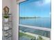 Stunning waterfront view visible from inside this home, framed by a large window, with stylish decor at 2807 W Hawthorne Rd # 11, Tampa, FL 33611