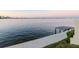 Expansive waterfront view featuring a private dock and the city skyline in the distance at sunset at 2807 W Hawthorne Rd # 11, Tampa, FL 33611