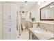 Well-lit bathroom featuring granite countertops, cabinetry, and neutral tile at 330 Woods Landing Trail, Oldsmar, FL 34677