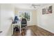 Bright bedroom featuring hardwood floors, a ceiling fan, and a large window with natural light at 330 Woods Landing Trail, Oldsmar, FL 34677