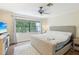 Cozy bedroom with large window, neutral decor, and ceiling fan at 330 Woods Landing Trail, Oldsmar, FL 34677