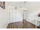 Bedroom with hardwood floors, a ceiling fan, and a large closet with white doors at 330 Woods Landing Trail, Oldsmar, FL 34677