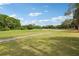 Picturesque view of a golf course with a walking path, sand trap and lush green grass at 330 Woods Landing Trail, Oldsmar, FL 34677
