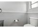 Simple but functional half bathroom with a white toilet and gray walls at 330 Woods Landing Trail, Oldsmar, FL 34677