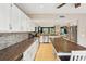 Bright kitchen with white cabinetry, stainless appliances, and a dining table island at 330 Woods Landing Trail, Oldsmar, FL 34677