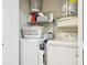 A laundry room with a washer, dryer, shelves, and laundry supplies at 330 Woods Landing Trail, Oldsmar, FL 34677