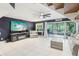 Bright living room with modern tiled floors and sliding glass doors to the screened patio at 330 Woods Landing Trail, Oldsmar, FL 34677
