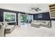Bright living room with modern tiled floors and sliding glass doors to the screened patio at 330 Woods Landing Trail, Oldsmar, FL 34677