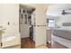 Primary bath featuring walk-in closet, granite countertop, and wood-look flooring at 330 Woods Landing Trail, Oldsmar, FL 34677