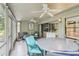 Relaxing screened patio with ceiling fans and comfortable outdoor furniture at 330 Woods Landing Trail, Oldsmar, FL 34677