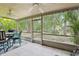 Cozy screened patio with a ceiling fan and comfortable seating area at 330 Woods Landing Trail, Oldsmar, FL 34677