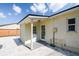 Back patio with a covered area, double doors, and gravel landscaping at 3315 W Pearl Ave, Tampa, FL 33611