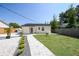 A charming backyard with a well-maintained lawn, paved walkway, and partial fence at 3315 W Pearl Ave, Tampa, FL 33611