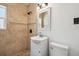 Bathroom featuring earth-tone tile shower and stylish vanity at 3315 W Pearl Ave, Tampa, FL 33611