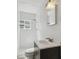 Bright bathroom featuring white tiled walls, updated vanity, and a window bringing in natural light at 3315 W Pearl Ave, Tampa, FL 33611
