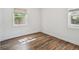 Cozy bedroom with natural light streaming through the windows, highlighting the warm wood flooring at 3315 W Pearl Ave, Tampa, FL 33611