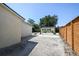 Long driveway leading to a home with a gravel landscape and privacy fence at 3315 W Pearl Ave, Tampa, FL 33611