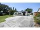 Inviting exterior view of home with a long driveway and lush landscaping under a clear sky at 3315 W Pearl Ave, Tampa, FL 33611