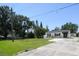 Home with spacious front lawn, tree, and long driveway at 3315 W Pearl Ave, Tampa, FL 33611