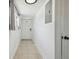 Hallway with neutral colors and tiled floor to front door at 3315 W Pearl Ave, Tampa, FL 33611