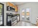 Modern kitchen with stainless steel appliances and tile flooring at 3315 W Pearl Ave, Tampa, FL 33611