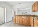 Kitchen area featuring granite countertops and wood cabinets at 3315 W Pearl Ave, Tampa, FL 33611
