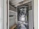 A tidy laundry area with a stacked washer and dryer and built-in shelving for storage at 3315 W Pearl Ave, Tampa, FL 33611
