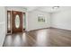 Bright living room showcasing beautiful wood floors, large windows, and a welcoming entryway at 3315 W Pearl Ave, Tampa, FL 33611